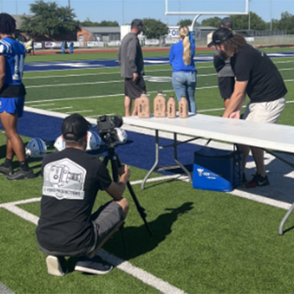 Ideas Collide team members shooting football scene. Mason Byrne and James West.