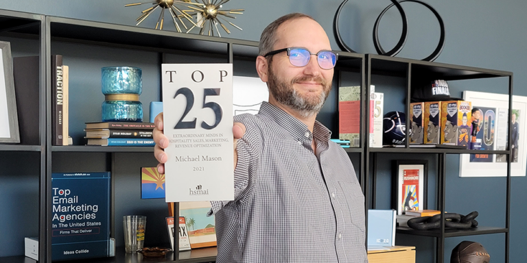 Mike Mason holding HSMAI Top 25 Lifetime Award